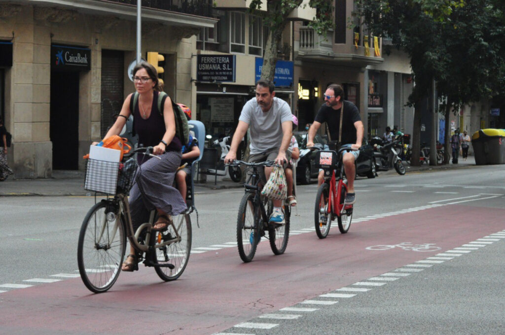 Three cyclist pedaling a on large lane